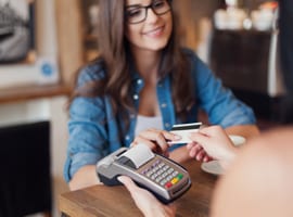 Woman using a credit card machine